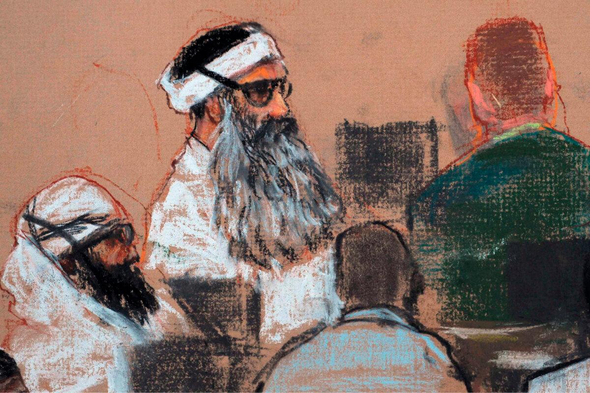 This Dec. 8, 2008, courtroom drawing by artist Janet Hamlin and reviewed by the U.S. military, shows Khalid Sheikh Mohammed, center, and co-defendant Walid Bin Attash, left, attending a pre-trial session at Guantanamo Bay Naval Base, Cuba. (Janet Hamlin, Pool/AP Photo)