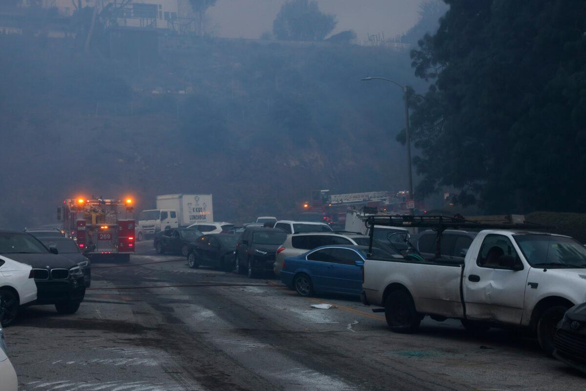 Vehicles are left stranded off the side of the road after residents tried to flee from the Palisades Fire in the Pacific Palisades neighborhood of Los Angeles on Jan. 7, 2025. (Etienne Laurent/AP Photo)