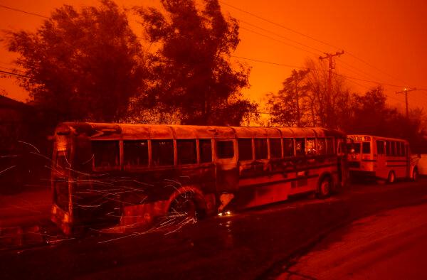 Sparks fly from the wheel of a burned school bus as the Eaton Fire moves through the area in Altadena, Calif., on Jan. 8, 2025. (Justin Sullivan/Getty Images)