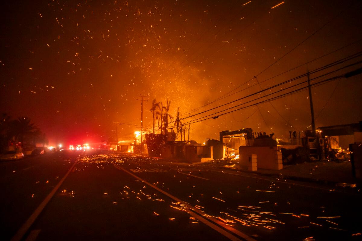 Strong winds blow embers as the Palisades Fire burns homes on the Pacific Coast Highway amid a powerful windstorm in Los Angeles on Jan. 8, 2025. (Apu Gomes/Getty Images)