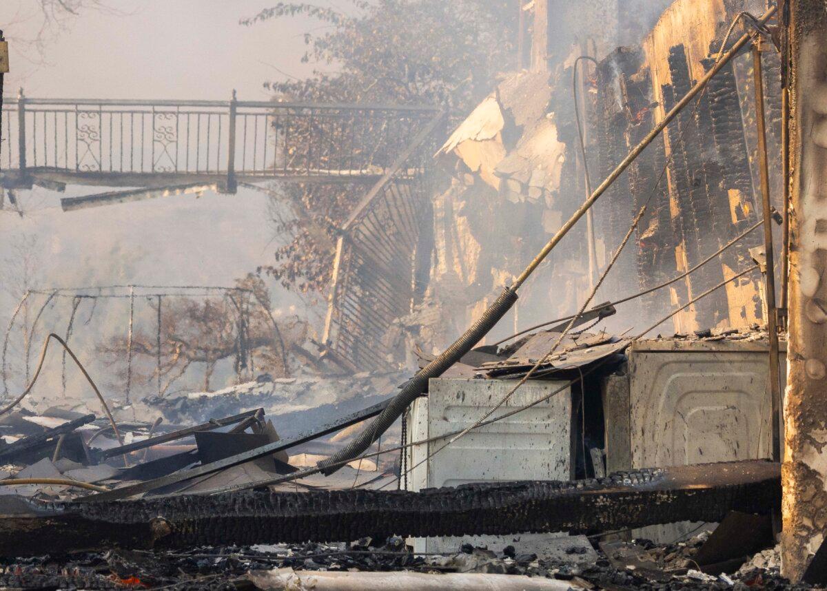 Homes and businesses sit damaged from the Palisades Fire burning near Los Angles, Calif., on Jan. 8, 2025. (John Fredricks/The Epoch Times)