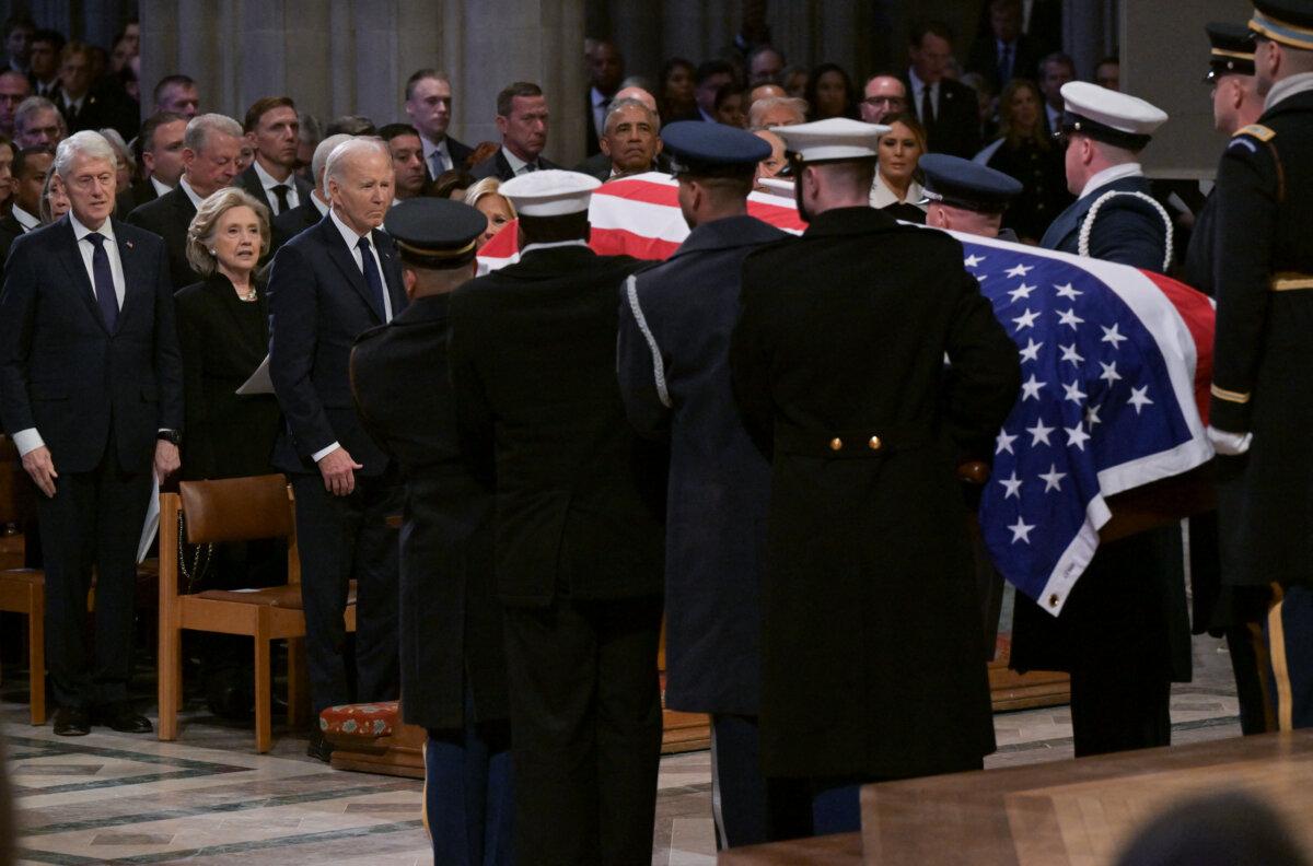 Former President Bill Clinton, former Secretary of State Hillary Clinton and President Joe Biden watch as the casket of former President Jimmy Carter is carried away at the end of his state funeral services at the National Cathedral on Jan. 9, 2025. (Ricky Carioti/AFP via Getty Images)