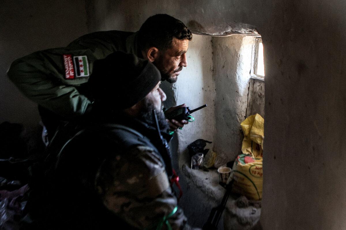 ISIS Terror Group Casts Shadow Over Post-Assad Syria | USNN World News Fighters from the Turkish-backed Syrian National Army faction look on from a window in a house at a position near the Tishrin Dam in the vicinity of Manbij, in the east of Syria's northern Aleppo province, on Jan. 10, 2025. (Aaref Watad / AFP via Getty Images)