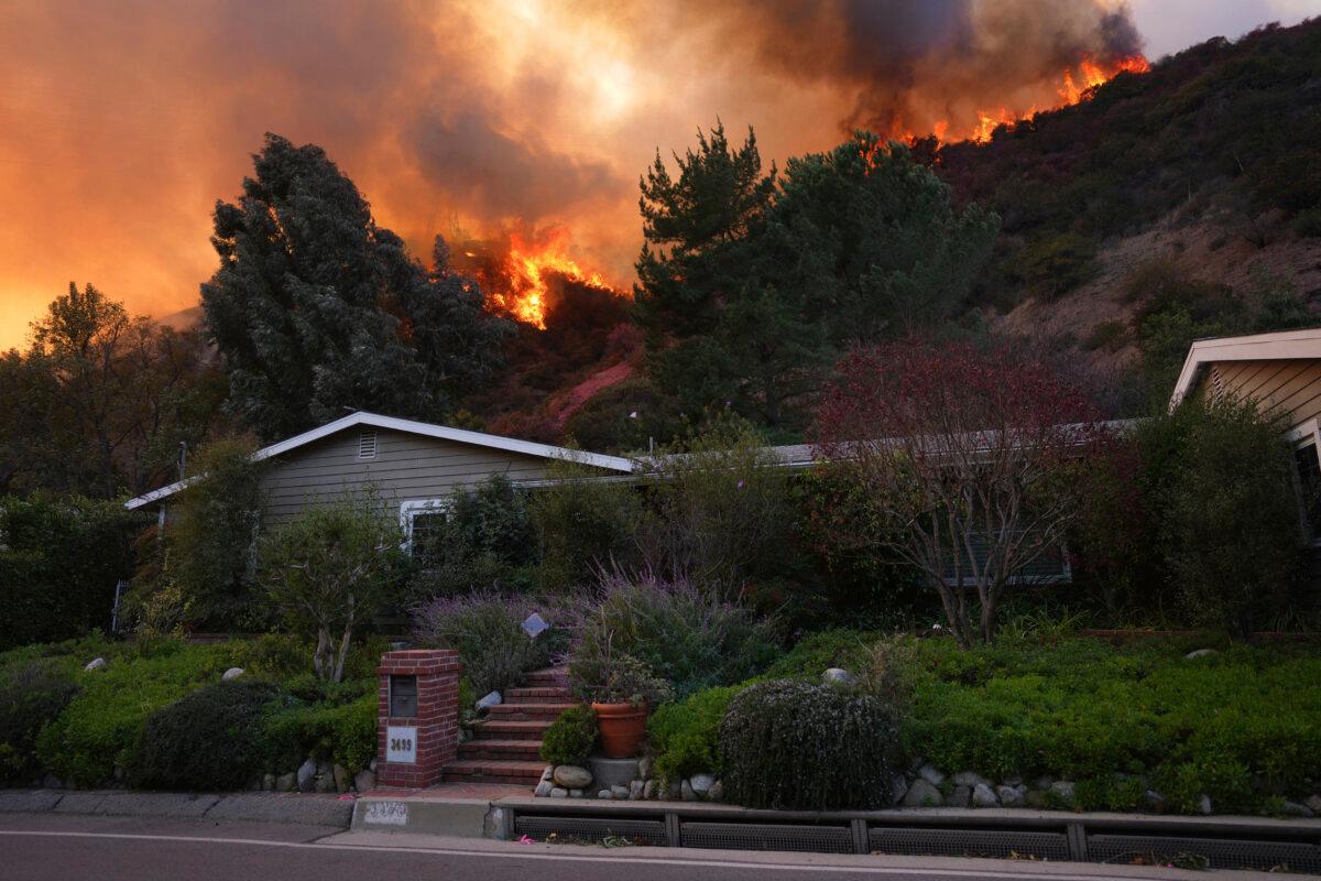 The Palisades Fire burns above a home in Mandeville Canyon in Los Angeles on Jan. 11, 2025. (Eric Thayer/AP Photo)