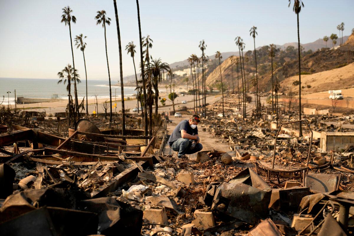 Kevin Marshall sifts through his mother's fire-ravaged property in the the Palisades Fire in the Pacific Palisades neighborhood of Los Angeles on Jan. 11, 2025. (John Locher/AP Photo)
