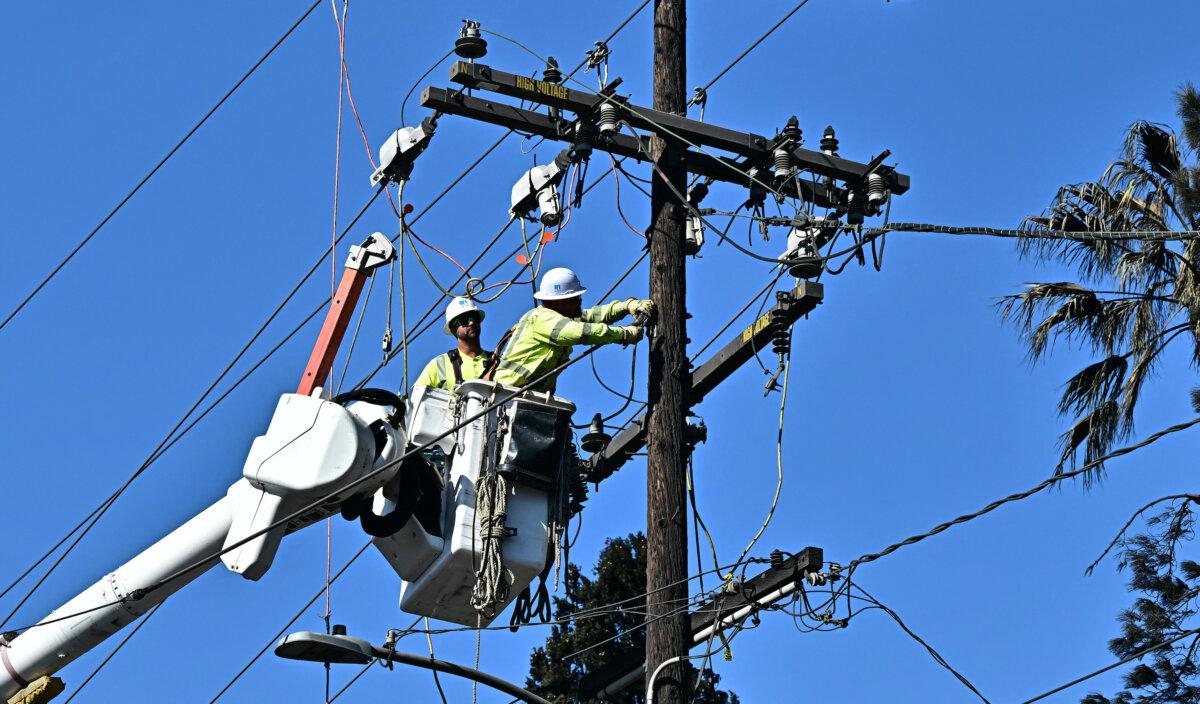 Workers from PG&E work on repairing and restoring power lines in Altadena, Calif., on Jan. 13, 2025. (Frederic J. Brown/AFP via Getty Images)