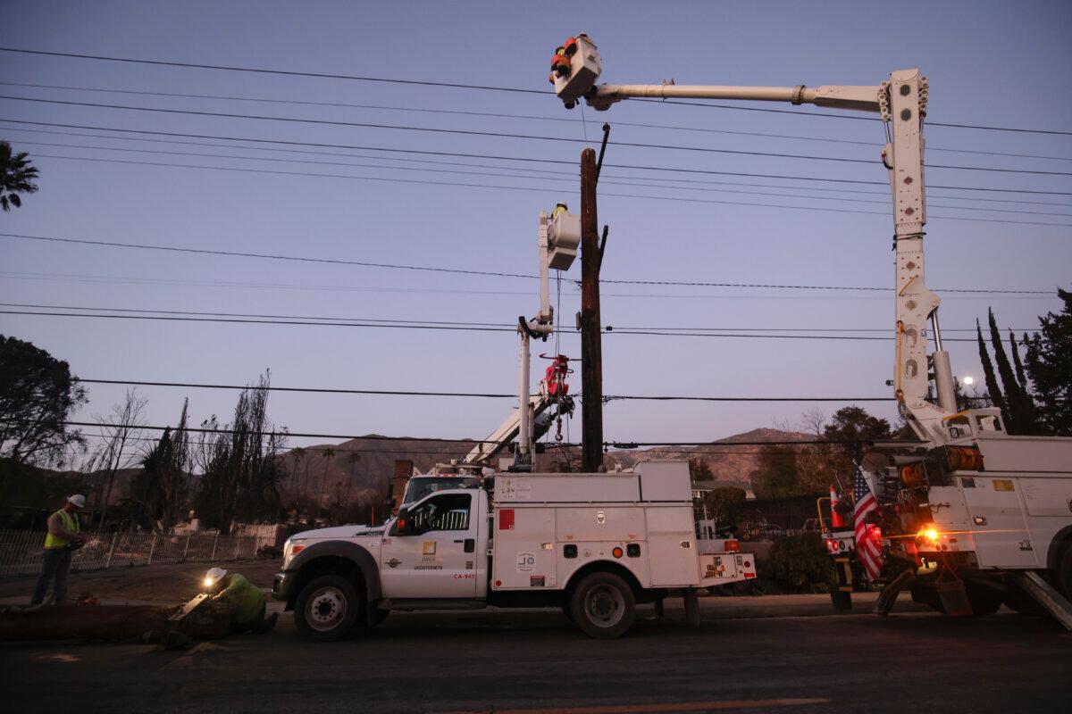 Southern California Edison workers service a utility pole in the aftermath of the Eaton Fire in Altadena, Calif., Jan. 12, 2025. (Ethan Swope/AP Photo)