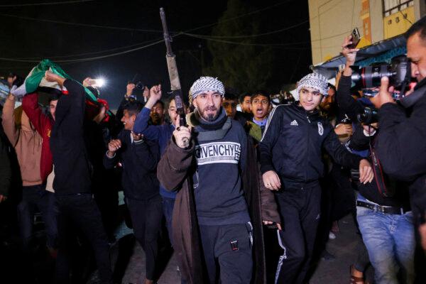 People celebrate along a street in Khan Yunis in the southern Gaza Strip on Jan. 15, 2025. Thousands of Gazans celebrated as news spread that a cease-fire and hostage release deal had been reached between Israel and Hamas, aimed at ending more than 15 months of war in the Palestinian Territories. (Bashar Taleb/AFP via Getty Images)