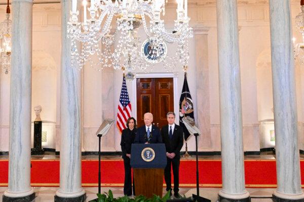 President Joe Biden, flanked by Vice President Kamala Harris and Secretary of State Antony Blinken, speaks about the Israel–Hamas cease-fire and hostage release deal in the Cross Hall of the White House on Jan. 15, 2025. (Roberto Schmidt/AFP via Getty Images)