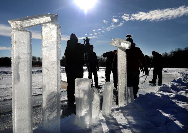 Chuck Zwilling and his crew worked on cutting the ice for their giant floating ice carousel—more than 425 feet across—on Green Prairie Fish Lake, using a custom rig that combines tracks from a snowblower and two chainsaws Thursday, Jan. 10, 2019, in Little Falls, Minnesota. Here, ice chunks pulled from the lake line the carousel as workers pull out more ice. (David Joles/The Minnesota Star Tribune/TNS)