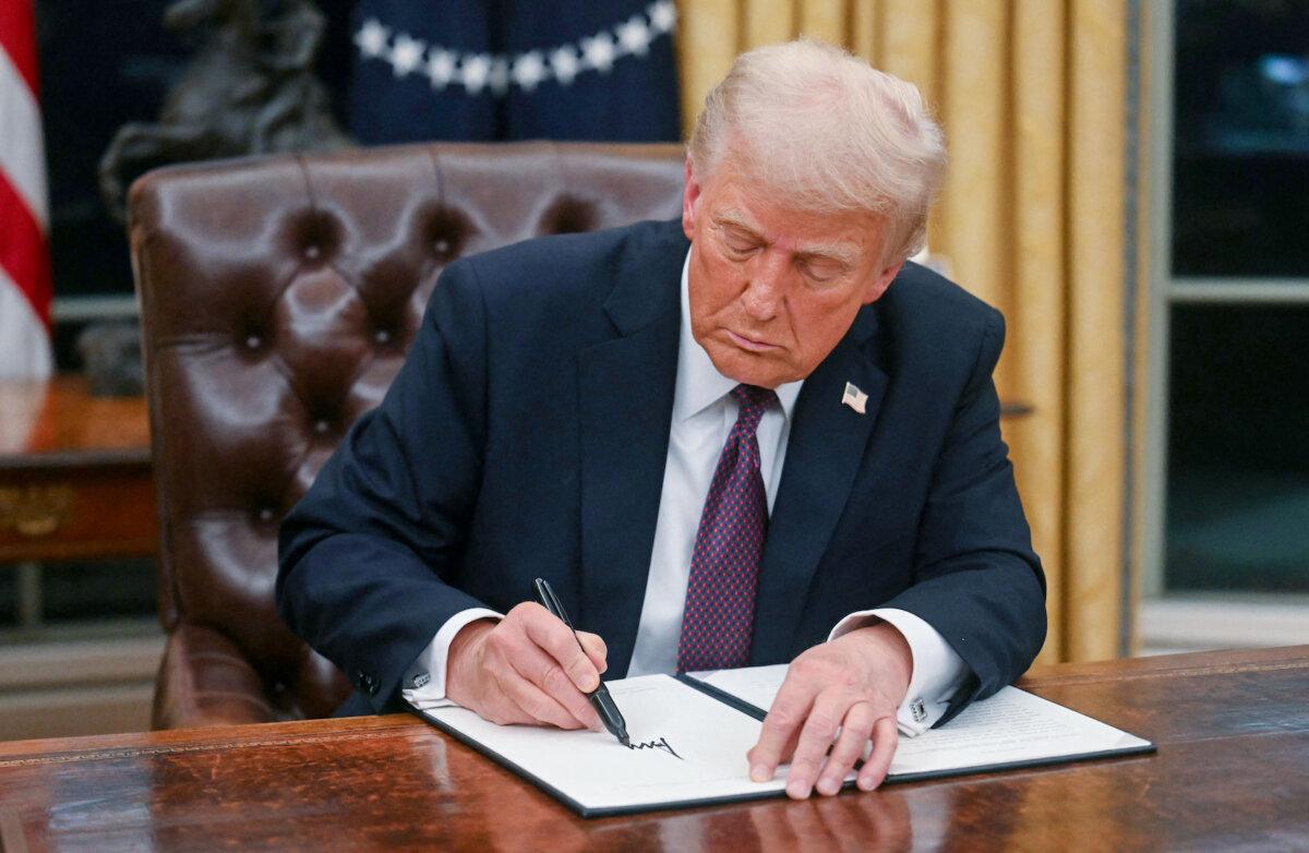 President Donald Trump signs an executive order to withdraw the United States from the World Health Organization, in the Oval Office on Jan. 20, 2025. (Jim Watson/AFP via Getty Images)