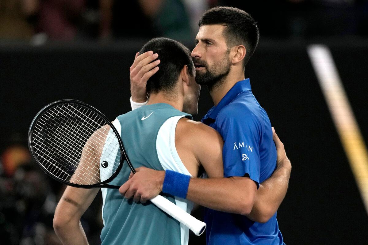 Novak Djokovic (R) of Serbia is congratulated by Carlos Alcaraz of Spain following their quarterfinal match at the Australian Open tennis championship in Melbourne, Australia, early on Jan. 22, 2025. (Ng Han Guan/AP Photo)