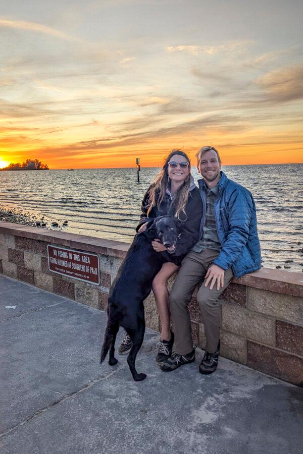 Central Florida explorer Patrick Connolly joins his girlfriend Karissa Bellile and Leo the black lab for a picture-perfect sunset over the Gulf Coast as seen from Robert J. Strickland Memorial Park in Hudson, Fla., on Jan. 1, 2025. (Patrick Connolly/Orlando Sentinel/TNS)