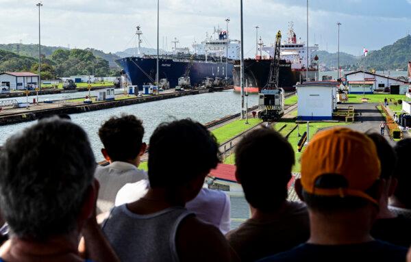 People look at two cargo ships entering the Miraflores Locks of the Panama Canal in Panama City on Jan. 22, 2025. (Martin Bernetti/AFP via Getty Images)