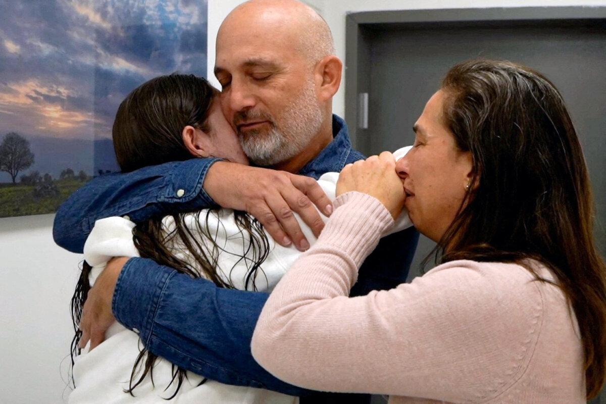 Released Israeli hostage Naama Levy, a soldier who was seized from her army base in southern Israel during the deadly Oct. 7, 2023, attack on Israel by Hamas, embraces loved ones after being released as part of a cease-fire and a hostages-prisoners swap deal between Hamas and Israel, in an unknown location, in a handout photo obtained by Reuters on Jan. 25, 2025. (Israel Defense Forces/Handout via Reuters)