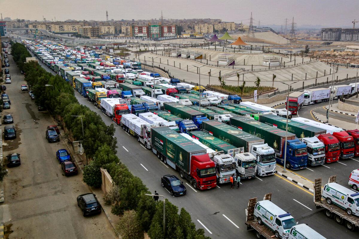 Trucks that are part of a humanitarian aid convoy carrying shipments to Palestinians in the Gaza Strip wait to start moving from al-Muqattam, Egypt, on Jan. 26, 2025. (Nader Nabil/AFP via Getty Images)