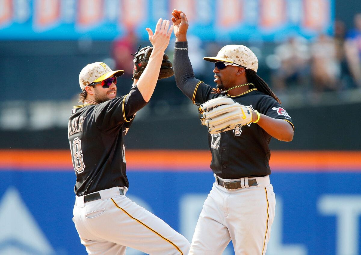Andrew McCutchen (22) and Neil Walker (18) of the Pittsburgh Pirates celebrate after defeating the New York Mets at Citi Field in the Flushing neighborhood of the Queens borough of New York City on May 26, 2014. (Jim McIsaac/Getty Images)