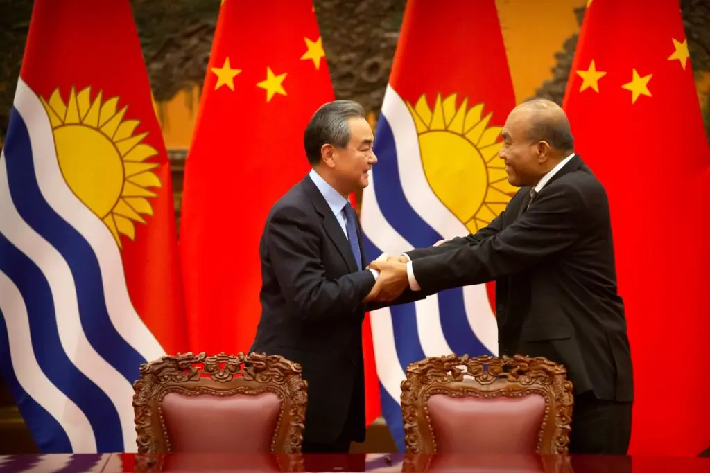 Chinese Foreign Minister Wang Yi (L) and Kiribati President Taneti Maamau shake hands during a signing ceremony at the Great Hall of the People in Beijing on Jan. 6, 2020. (Mark Schiefelbein/Pool/AFP via Getty Images)