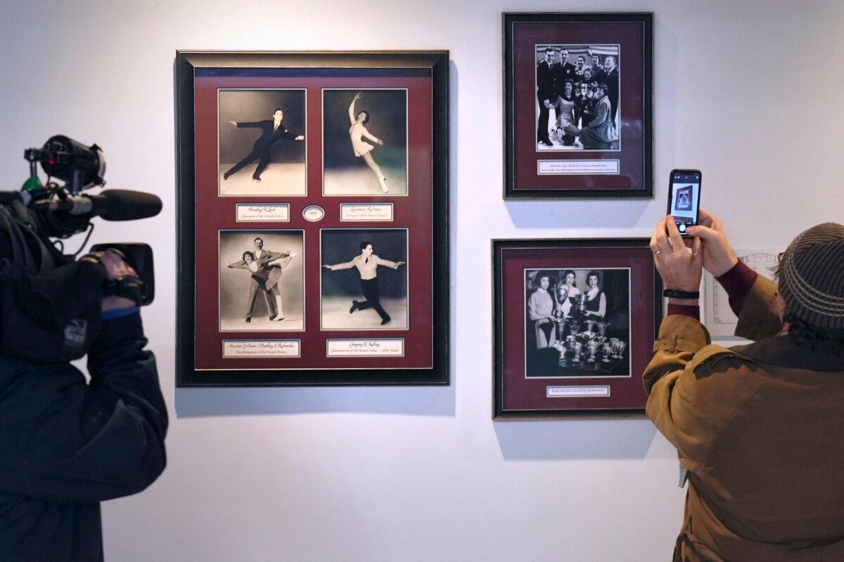 Journalists photograph a memorial to local skaters killed in a 1961 plane crash at The Skating Club of Boston, in Norwood, Mass., on Jan. 30, 2025. (Charles Krupa/AP Photo)