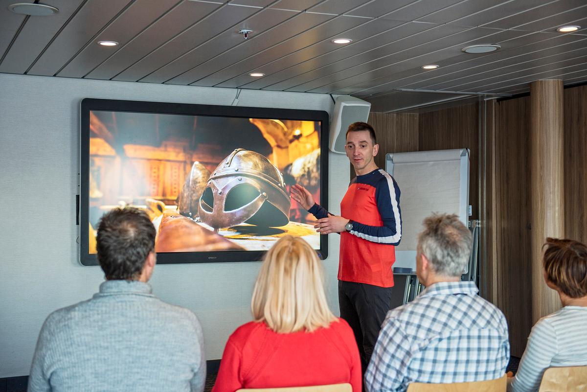 Passengers learn about Norwegian history and culture in an onboard lecture with the expedition team. (Agurtxane Concellon / Agurtxane Concellon Photograhy)