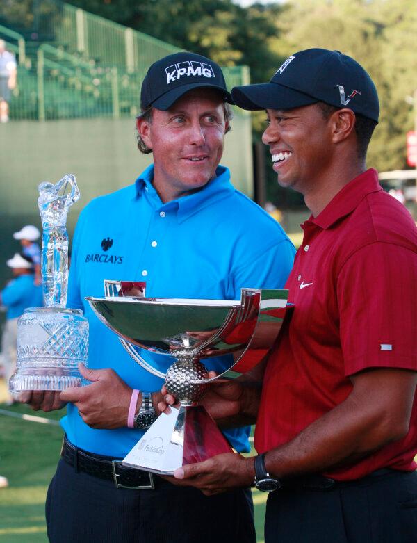 Phil Mickelson, left, and Tiger Woods pose with their trophies after the final round of The Tour Championship golf tournament at East Lake Golf Club in Atlanta on Sept. 27, 2009. (Dave Martin/AP Photo)