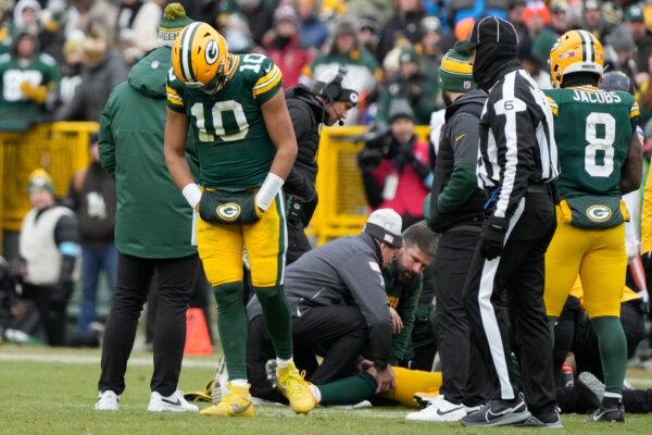 Green Bay Packers quarterback Jordan Love (10) reacts as wide receiver Christian Watson, bottom, is checked on during the first half of an NFL football game against the Chicago Bears in Green Bay, Wis., on Jan. 5, 2025. (Morry Gash/AP Photo)