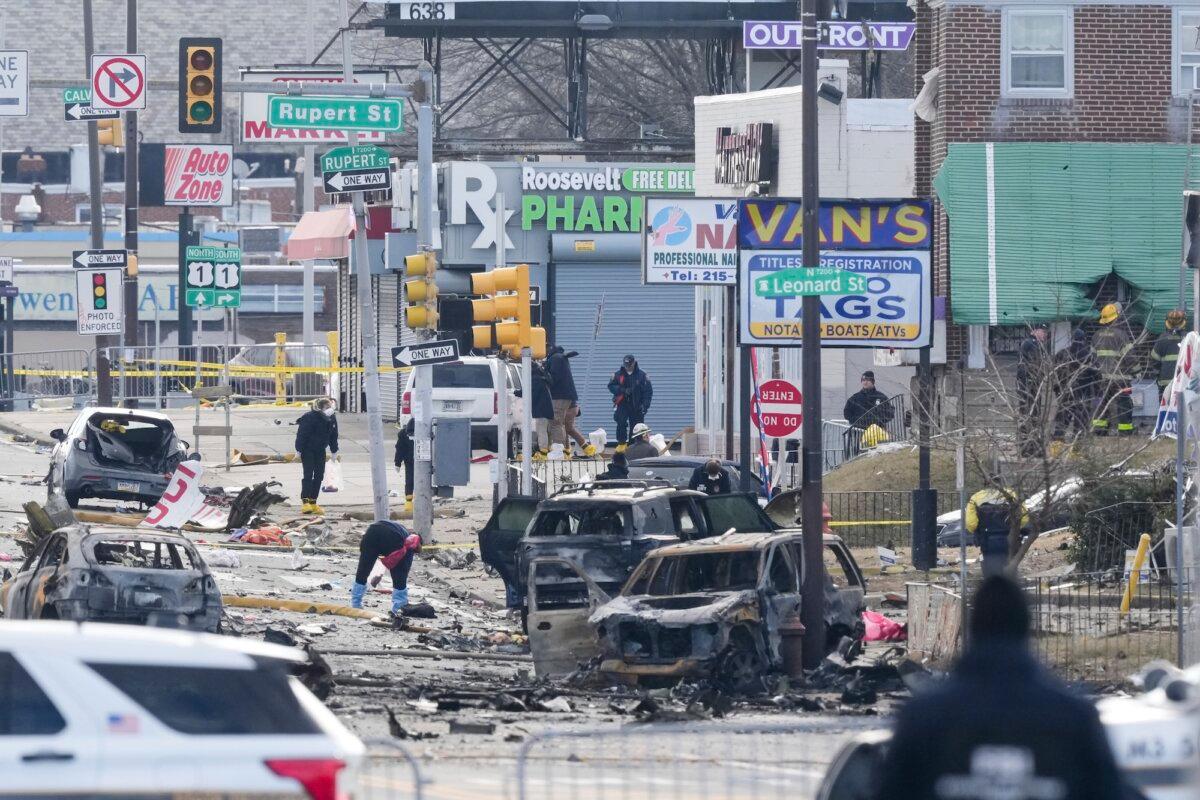 Investigators work the scene after a Jan. 31 small plane crash in Philadelphia, on Feb. 1, 2025. (Matt Rourke /AP Photo)
