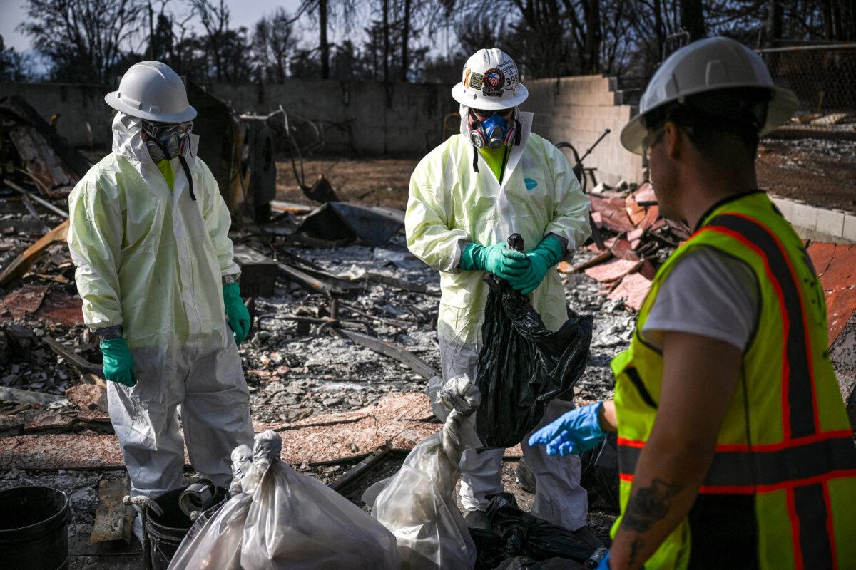 Contractors for the Environmental Protection Agency (EPA) remove household hazardous waste as they search through homes damaged and destroyed by the Eaton Fire in the Altadena neighborhood of Los Angeles County, California, on Jan. 30, 2025. (Patrick T. Fallon/AFP via Getty Images)