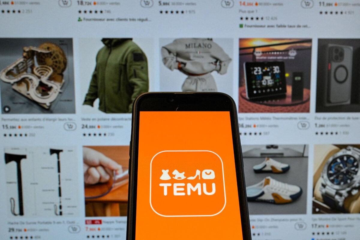 The logo of Chinese e-commerce company Temu is displayed on a phone held in front of a screen showing the company's website, in Brussels, on Nov. 4, 2024. (Nicolas Tucat/AFP via Getty Images)