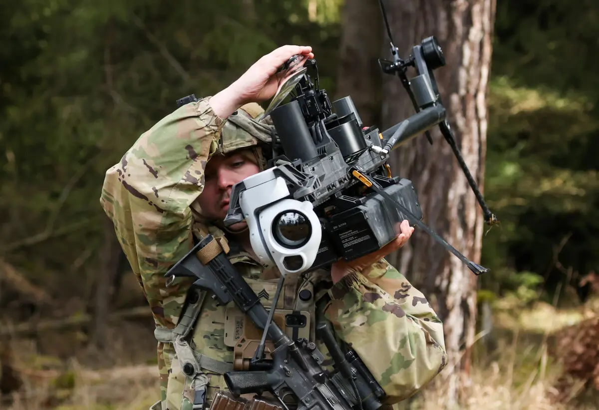 Hegseth Outlines 5 Pillars for Overhauling US Arms Procurement Process | USNN World News A soldier from a LUAS (Lethal Unmanned Aircraft System) platoon of the U.S. Army 3rd Brigade, 10th Mountain Division, carries a Ghost-X helicopter surveillance drone near Hohenfels, Germany, on Feb. 3, 2025. (Sean Gallup/Getty Images)