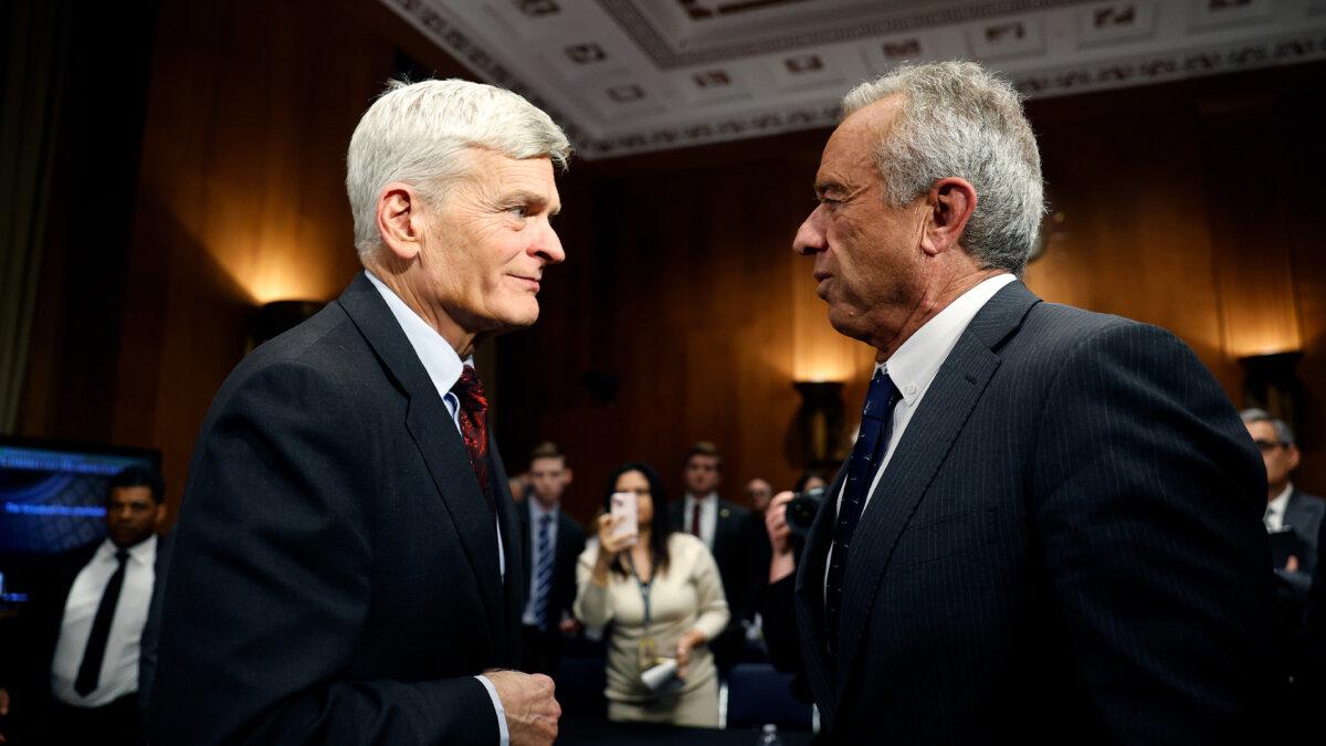 Robert F. Kennedy Jr. (R), President Donald Trump’s nominee for secretary of Health and Human Services, speaks with Sen. Bill Cassidy (R-La.) after testifying before the Senate Committee on Health, Education, Labor, and Pensions confirmation hearing at the Dirksen Senate Office Building in Washington, on Jan. 30, 2025. (Kevin Dietsch/Getty Images)