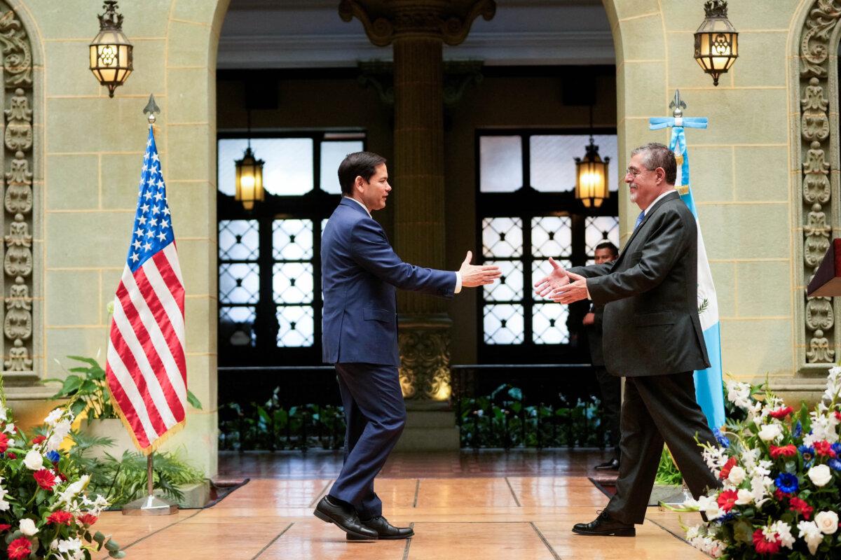 Secretary of State Marco Rubio and Guatemalan President Bernardo Arevalo reach out to shake hands at the end of their joint news conference at the National Palace in Guatemala City, on Feb. 5, 2025. (Mark Schiefelbein/Reuters)