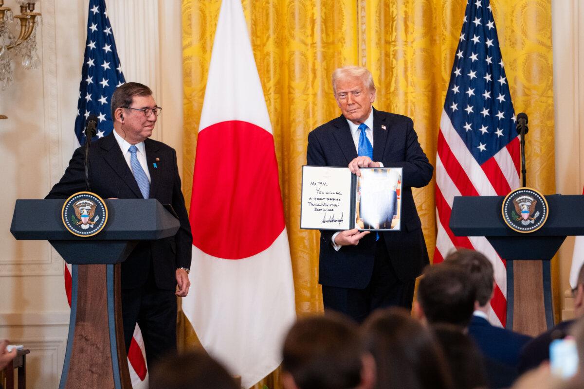 President Trump holds a gift for Japanese Prime Minister Shigeru Ishiba during a press conference at the East Room of the White House on Feb. 7, 2025. (Madalina Vasiliu/The Epoch Times)