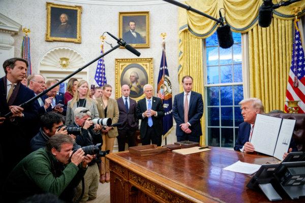 President Donald Trump signs a series of executive orders, including 25 percent tariffs on steel and aluminum, in the Oval Office on Feb. 10, 2025. (Andrew Harnik/Getty Images)