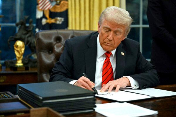President Donald Trump signs an executive order in the Oval Office of the White House on Feb. 10, 2025. (Andrew Caballero-Reynolds/AFP via Getty Images)