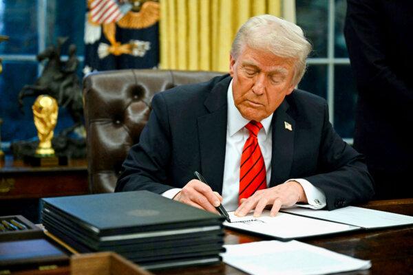 President Donald Trump signs an executive order in the Oval Office of the White House on Feb. 10, 2025. (Andrew Caballero-Reynolds/AFP via Getty Images)