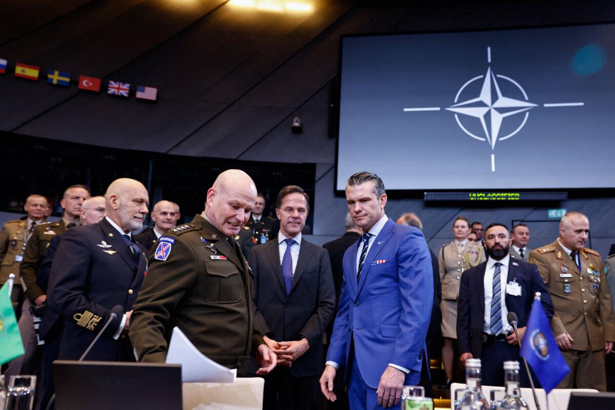 NATO Secretary General Mark Rutte (C) and U.S. Defense Secretary Pete Hegseth (center R) react prior to the start of the NATO Ministers of Defence meeting at NATO Headquarters in Brussels on Feb. 13, 2025. (Simon Wohlfahrt/AFP via Getty Images)