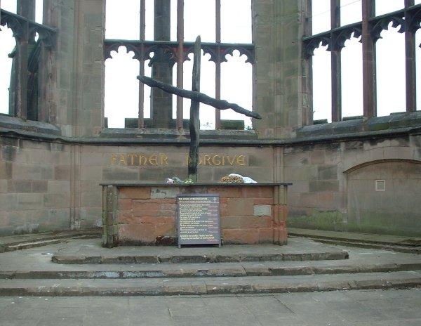 The words "Father Forgive" were written on the ruined walls of the St Michael's Cathedral, behind two roof timbers that had fallen in the shape of a cross. (sannse/CC BY-SA 3.0)