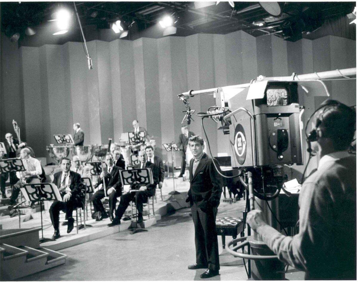 Leonard Bernstein with members of the Philharmonic rehearsing for a television broadcast, circa 1958. Bert Bial, New York Philharmonic Archives. (<a href="https://en.wikipedia.org/wiki/User:Barbara_Haws">Barbara Haws</a>/<a href="https://creativecommons.org/licenses/by/2.5/">CC BY 2.5</a>)
