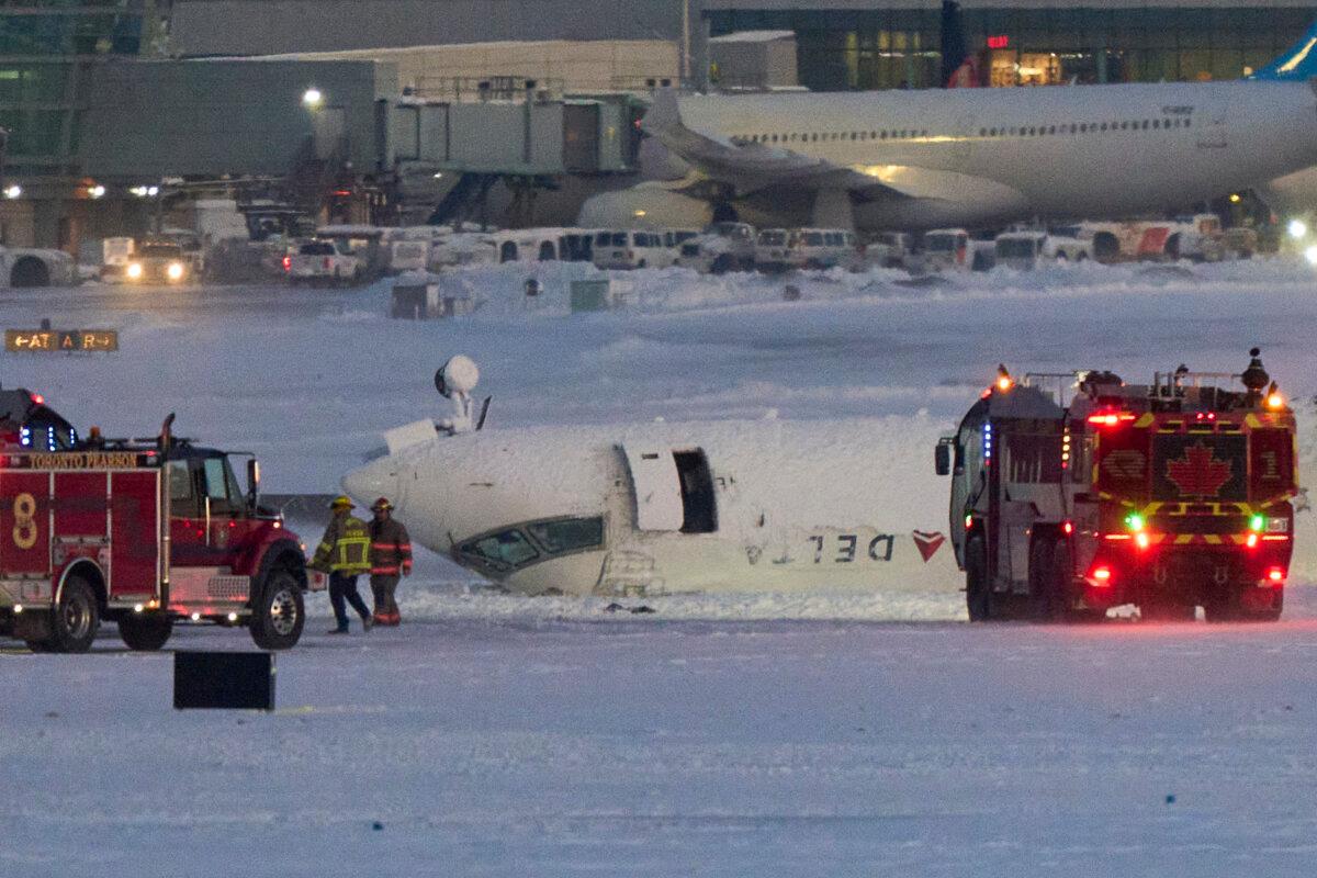 A Delta airlines plane sits on its roof after crashing upon landing at Toronto Pearson Airport in Toronto, Canada, on Feb. 17, 2025. (Geoff Robins/AFP via Getty Images)
