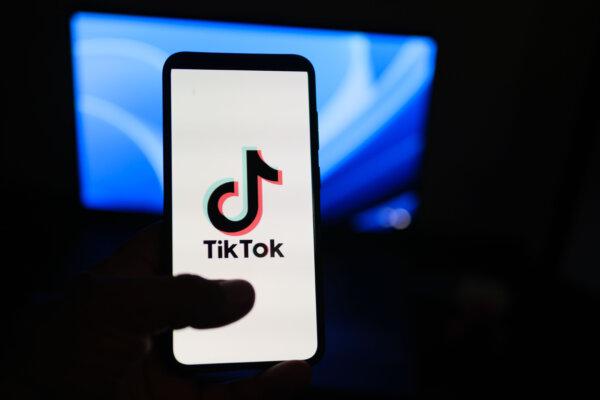 A man holds a phone displaying the TikTok app. The number of young consumers interested in skin-care products has soared mostly because of social media influencers, according to the latest research. (Oleksii Pydsosonnii/The Epoch Times)