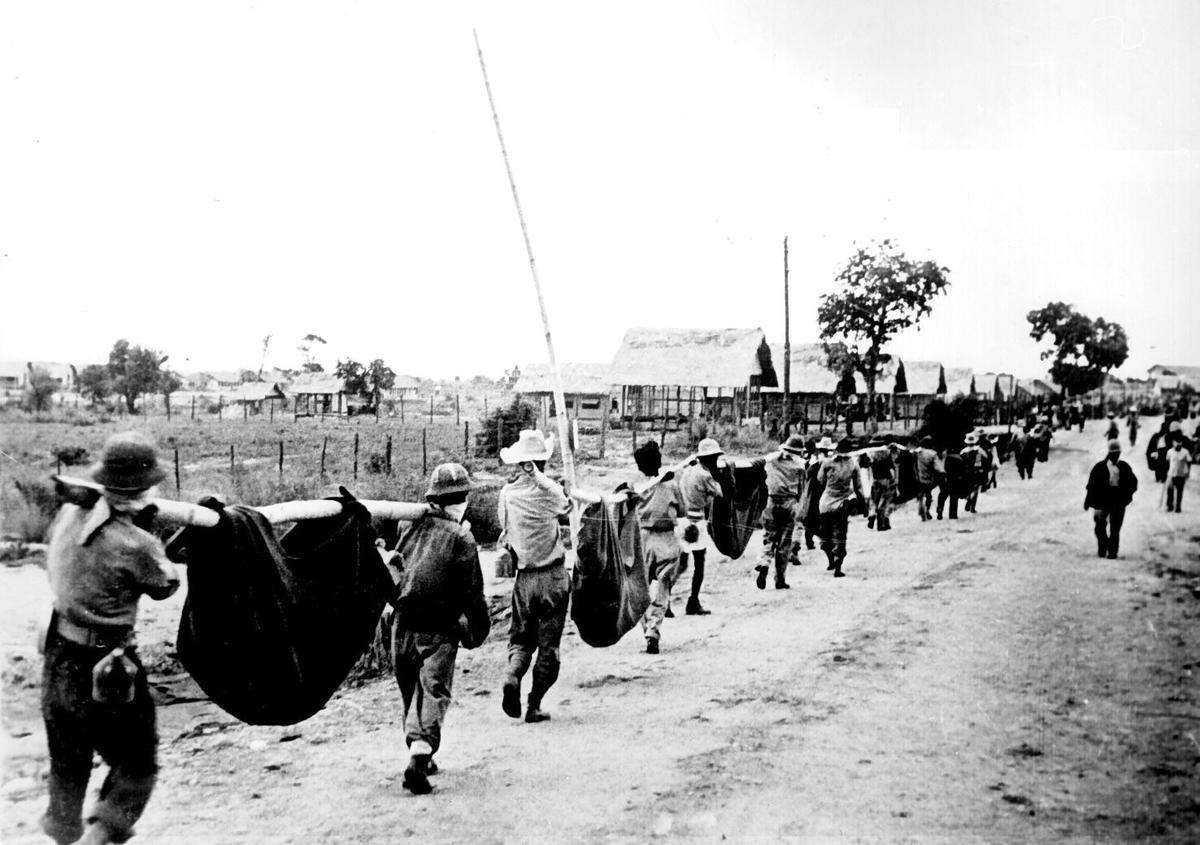 This 1942 Japanese picture shows American POWs carrying their fallen comrades. (Public Domain)