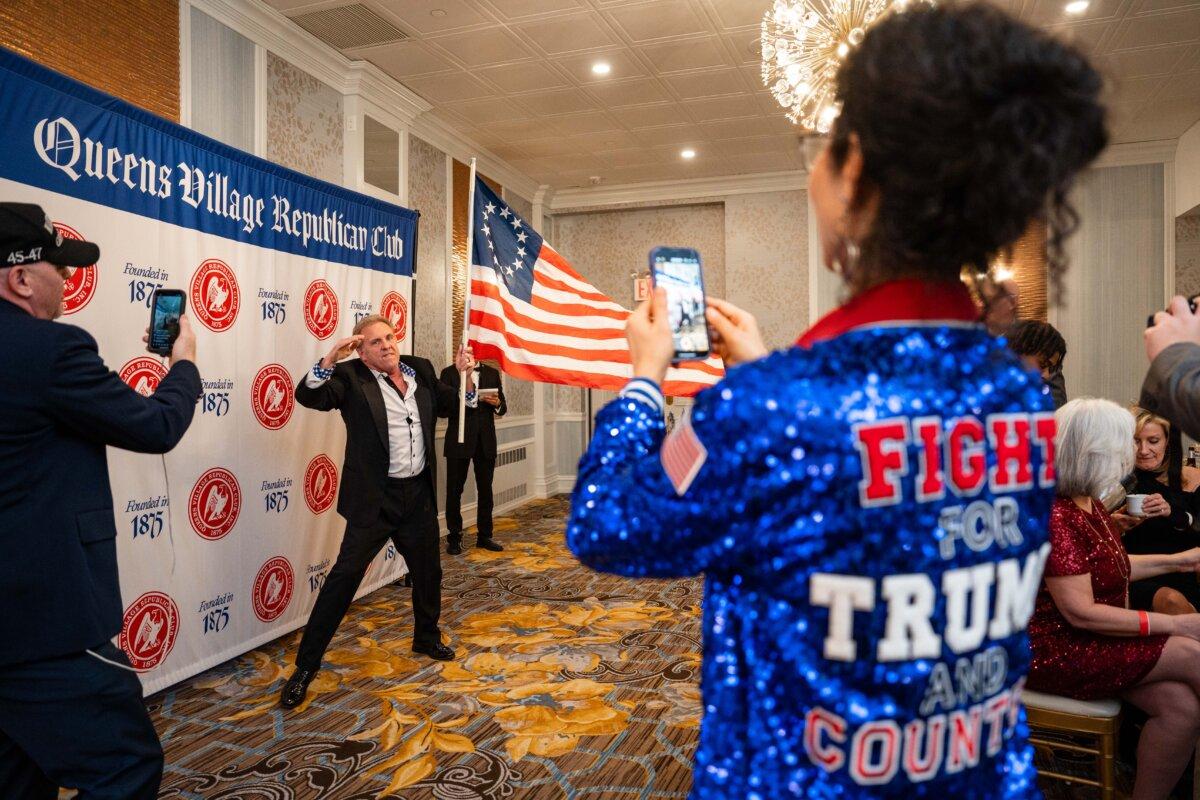 Joe Verderber Jr., also known as “Joe the Box,” dances with a U.S. flag at the Queens Village Republican Club’s 150th Anniversary Lincoln Dinner in Queens Village, N.Y., on March 2, 2025. (Samira Bouaou/The Epoch Times)