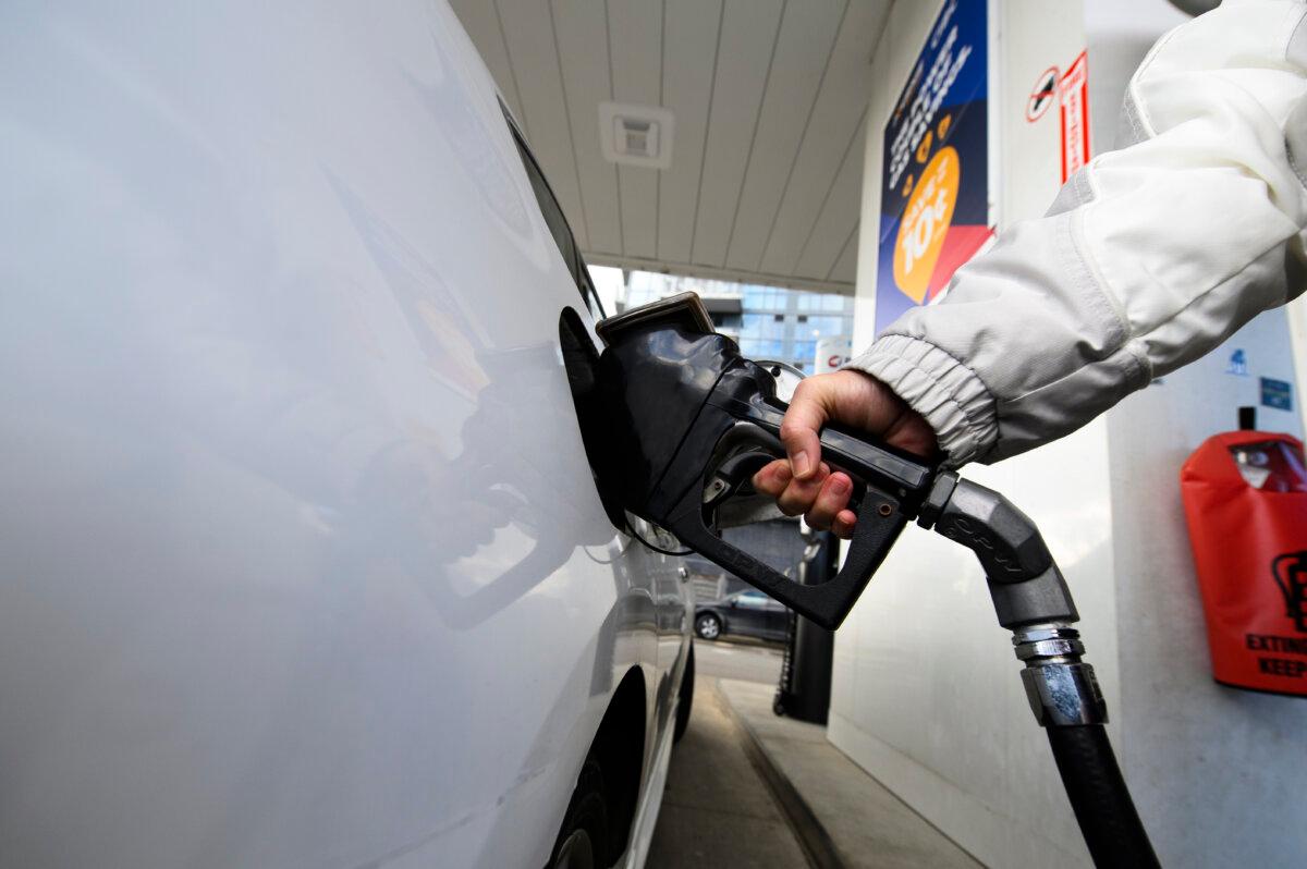 A man pumps gas into his vehicle at a gas station in Mississauga, Ont., on Feb. 13, 2024. (The Canadian Press/Christopher Katsarov)