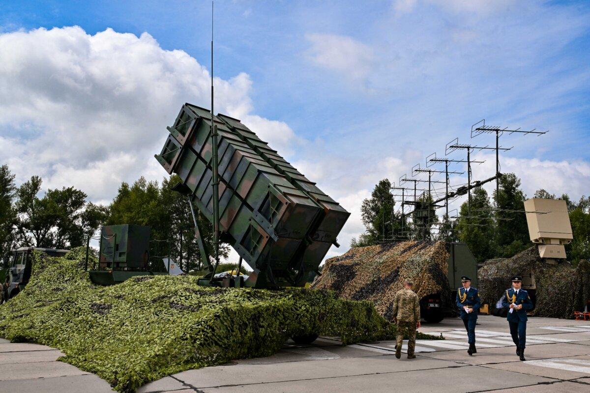 Ukrainian servicemen walk past a Patriot air defence system at an undisclosed area, on Aug. 4, 2024. (Sergei Supinsky/AFP via Getty Images)