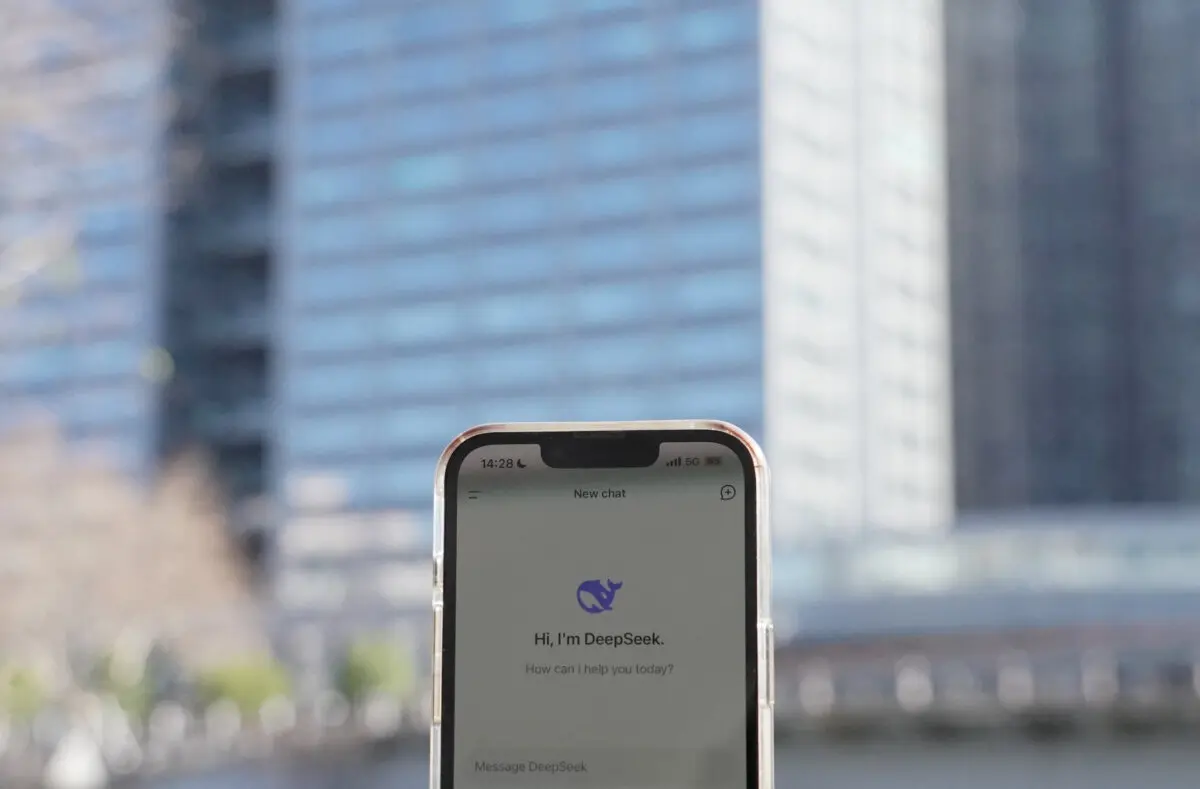 This photo illustration shows the DeepSeek app on a mobile phone in front of the building housing the headquarters of Chinese AI startup DeepSeek in Hangzhou, in China's eastern Zhejiang province, on Jan. 28, 2025. (Agatha Cantrill/AFP via Getty Images)