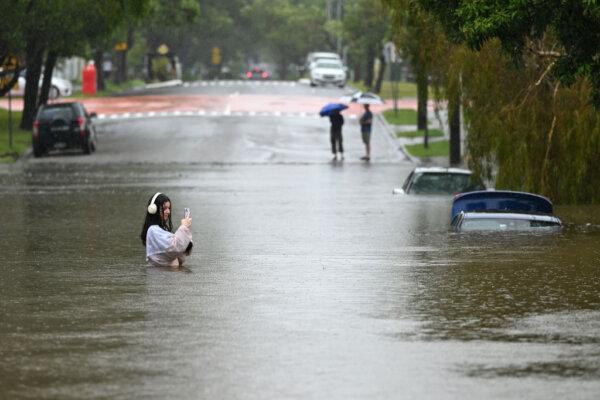 A resident walks on a flooded Edmonstone Street in the suburb of Newmarket in Brisbane, Australia, on March 9, 2025. (Albert Perez/Getty Images)