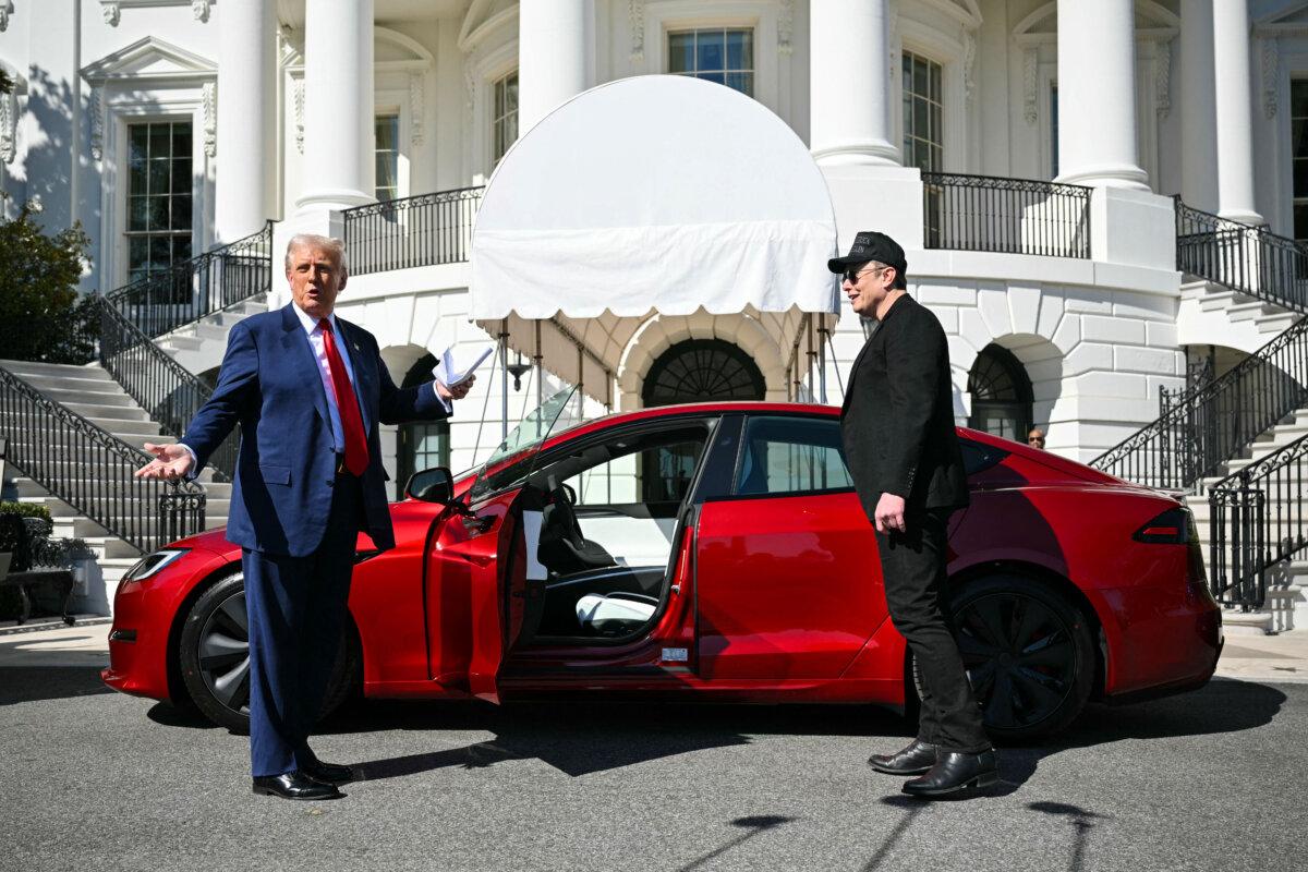 U.S. President Donald Trump and Tesla CEO Elon Musk speak to the press as they stand next to a Tesla vehicle at the White House on March 11, 2025, in Washington. (Mandel Ngan/AFP via Getty Images)