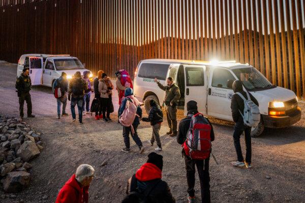 Illegal immigrants turn themselves in to Border Patrol agents after crossing over a section of the southern border wall in Ruby, Arizona, on Jan. 5, 2025. (Brandon Bell/Getty Images)