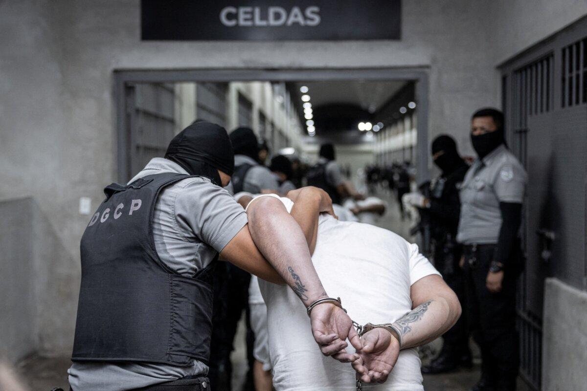 Salvadoran police officers escort alleged members of the Tren de Aragua recently deported by the U.S. government to be imprisoned in the Terrorism Confinement Center (CECOT) prison, as part of an agreement with the Salvadoran government, in Tecoluca, El Salvador, in this handout image obtained March 16, 2025. (Secretaria de Prensa de la Presidencia/Handout via Reuters)